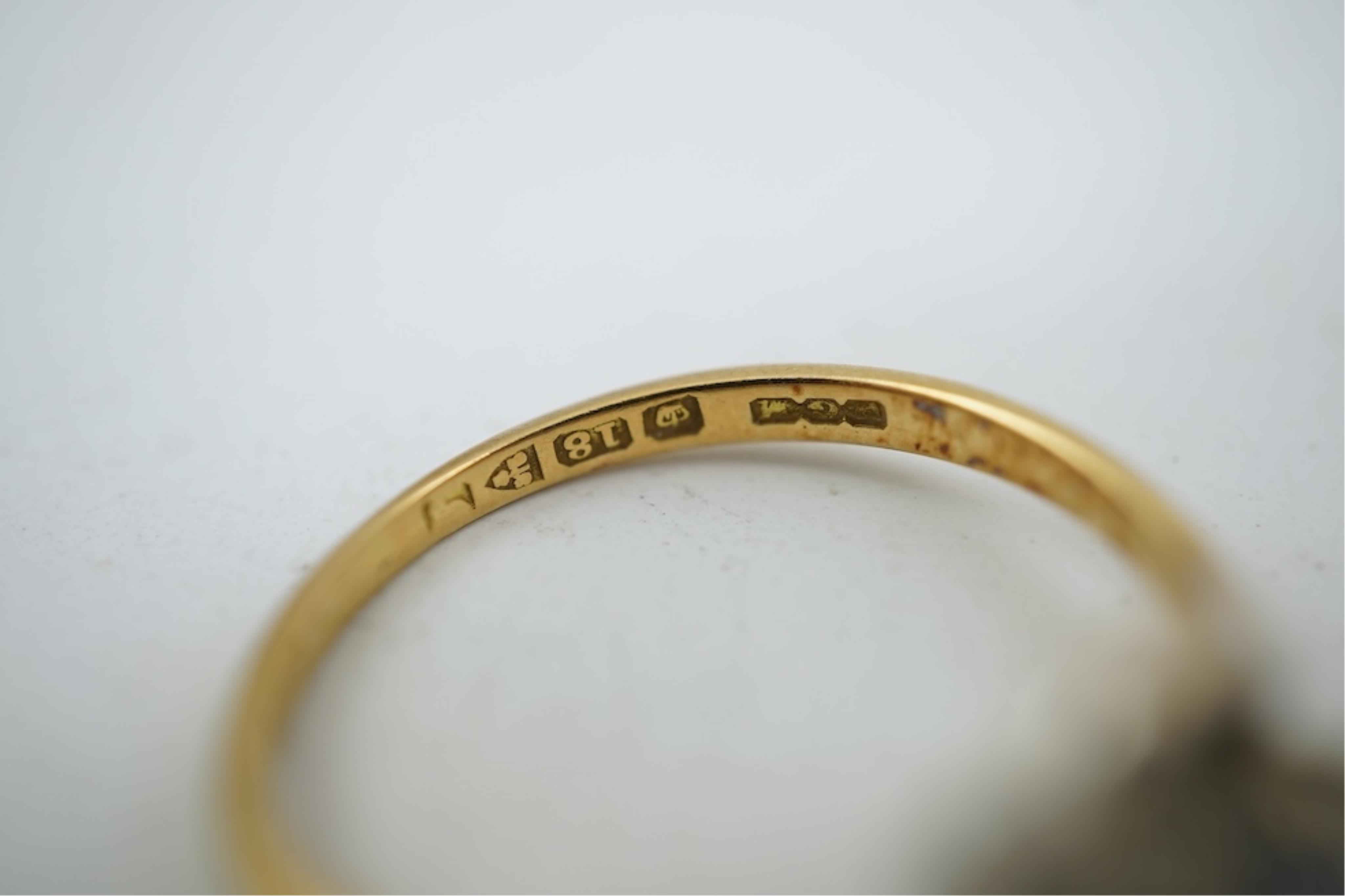An early 20th century 18ct gold, sapphire and diamond set three stone crossover ring, size P/Q, gross weight 2.4 grams.
